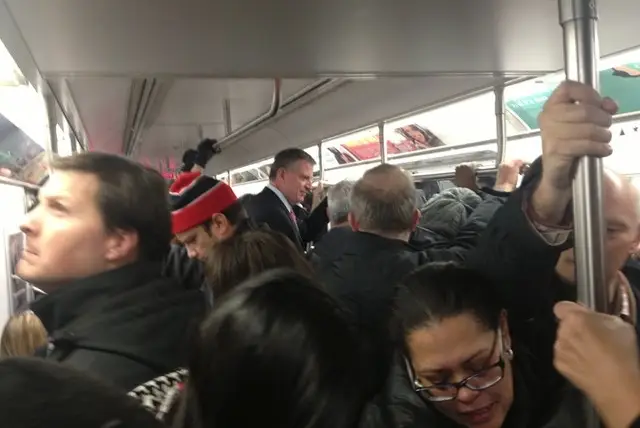 De Blasio riding the subway with little people in 2013.